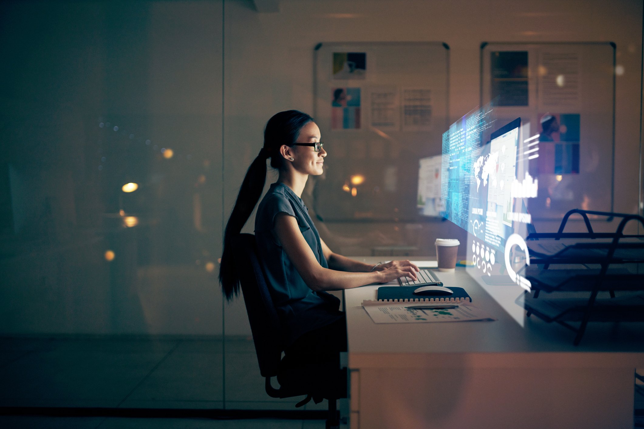 Businesswoman working on digital dashboards, symbolizing mYngle’s corporate language training and employee development solutions.