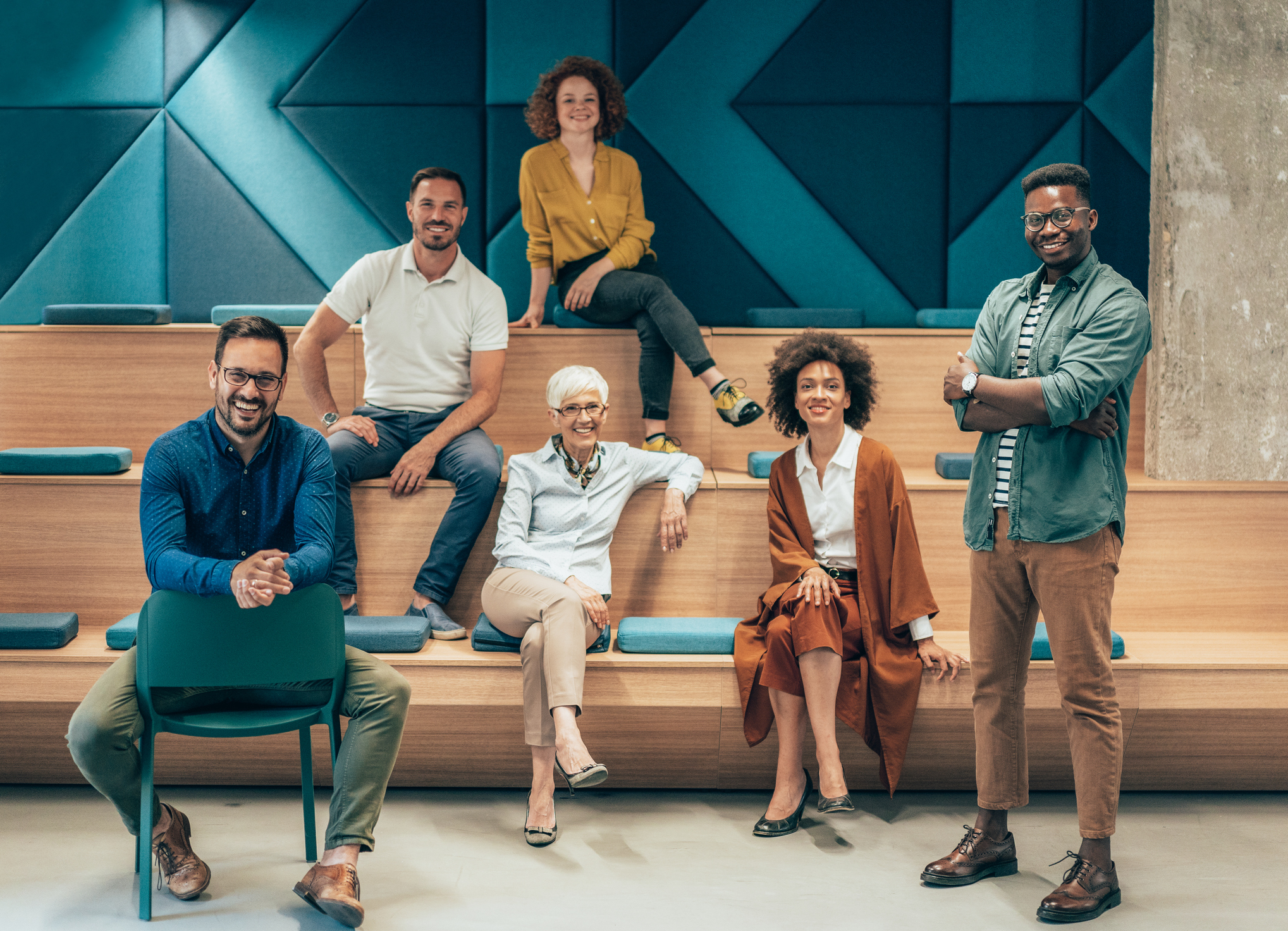 Diverse business team collaborating in a modern workplace, representing mYngle’s corporate language training and employment development solutions.